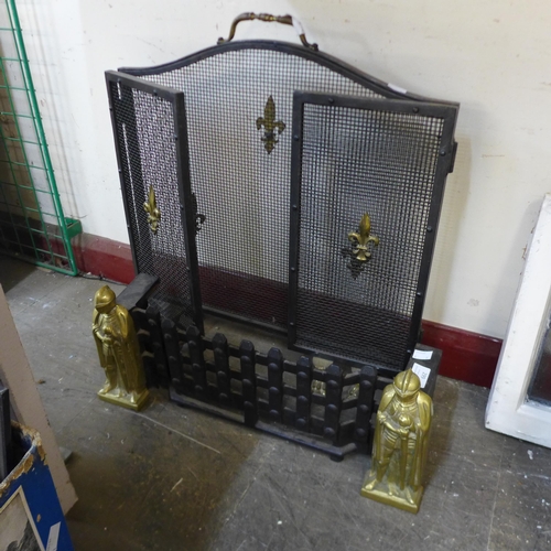 299 - A cast iron fire front and a French fleur de lys fire screen