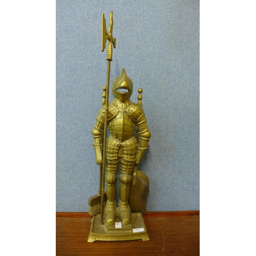 307 - A brass companion set on figural knight stand