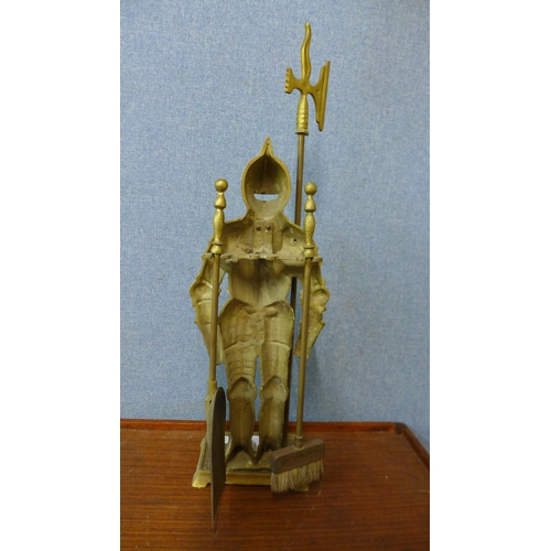 307 - A brass companion set on figural knight stand