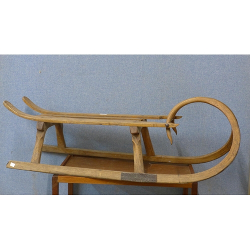 309 - A vintage child's elm sledge