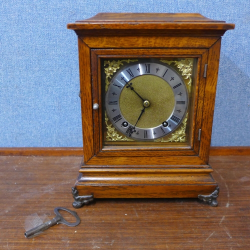 350 - An early 20th Century carved oak mantel clock, marked Hitchcock & Son, Market Place, Bingham