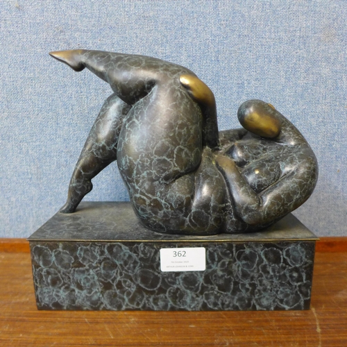 362 - An abstract bronze figure of a reclining nude female