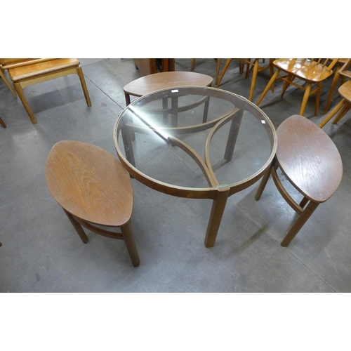 49 - A Nathan Trinity teak and glass topped circular nest of tables