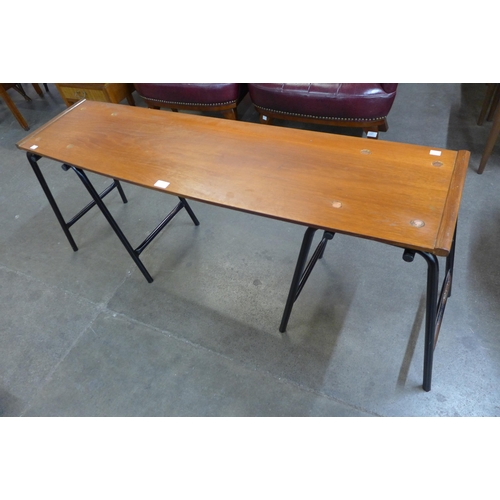 50 - A teak and black tubular metal hall table