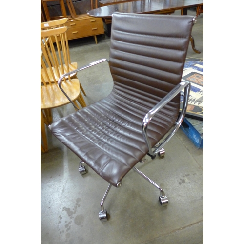 58 - An Eames style chrome and brown leather revolving desk chair