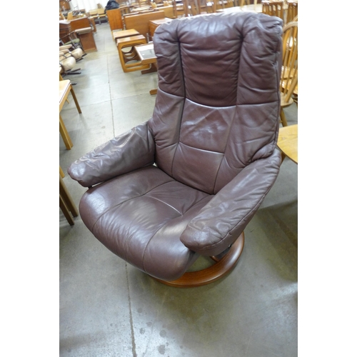 59 - An Ekorness beech and brown leather Stressless revolving lounge chair