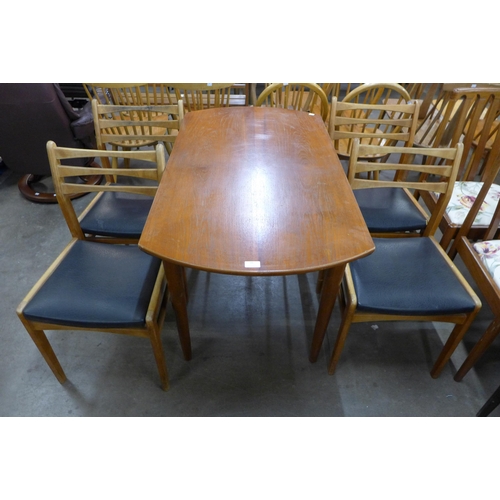 60 - A teak drop leaf table and four chairs