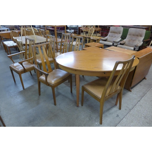 66 - A teak oval extending dining table and six Nathan teak dining chairs