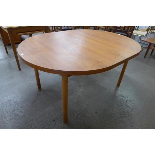 81 - A teak extending dining table