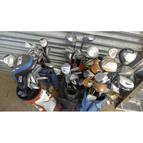 2232 - A Selection of gold clubs including woods irons and putters