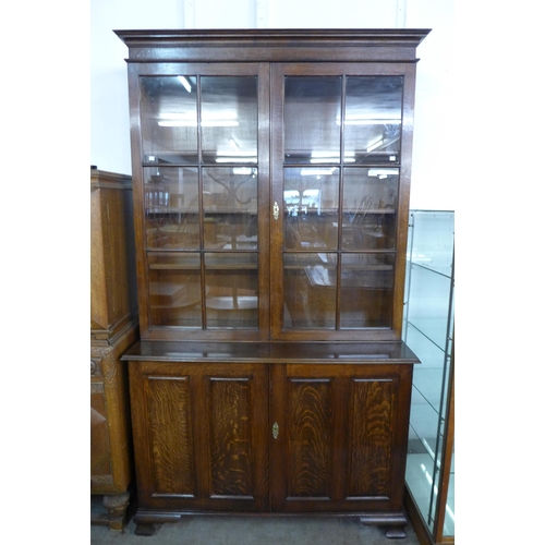 80 - A George III style oak four door bookcase