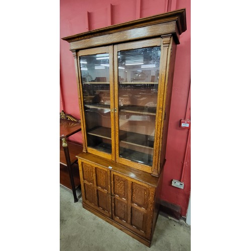 61 - A Victorian Aesthetic Movement carved oak four door bookcase