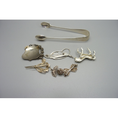 1008 - A pair of Edwardian silver sugar bows, 30g, a silver leaf brooch, three filigree brooches, one marke... 