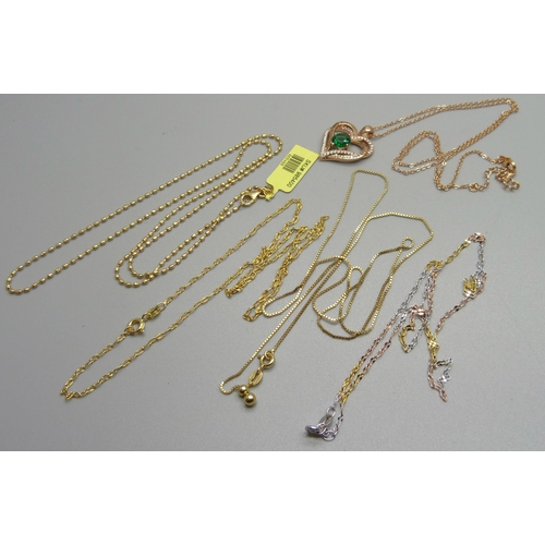 1018 - Five silver gilt chains, one with a silver gilt heart shaped pendant set with a green stone