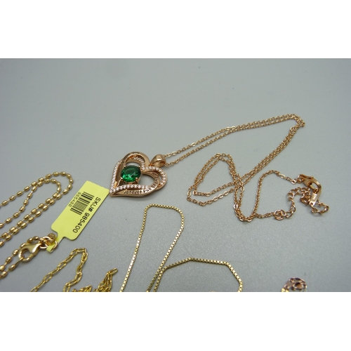 1018 - Five silver gilt chains, one with a silver gilt heart shaped pendant set with a green stone