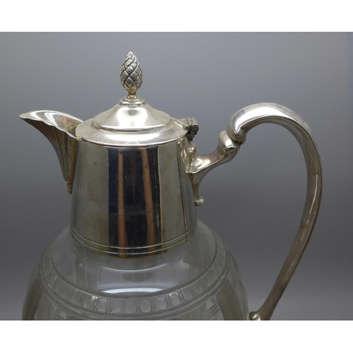 607 - A claret jug with silver plated top