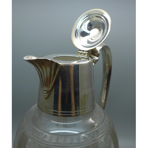 607 - A claret jug with silver plated top