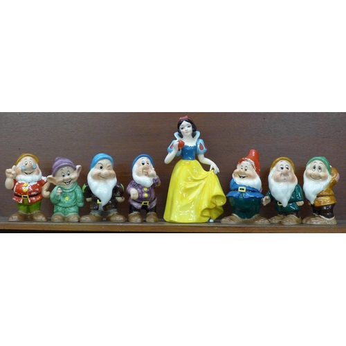 608 - A set of Disney Japan Snow White and the Seven Dwarfs figures, (Snow White, Sneezy, Happy and Doc wi... 