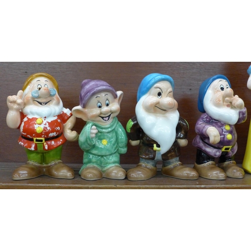 608 - A set of Disney Japan Snow White and the Seven Dwarfs figures, (Snow White, Sneezy, Happy and Doc wi... 