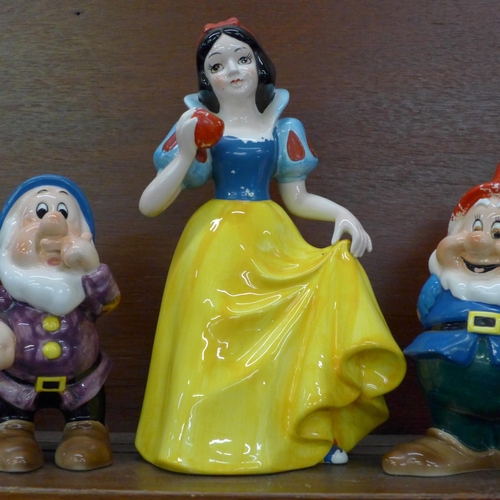 608 - A set of Disney Japan Snow White and the Seven Dwarfs figures, (Snow White, Sneezy, Happy and Doc wi... 