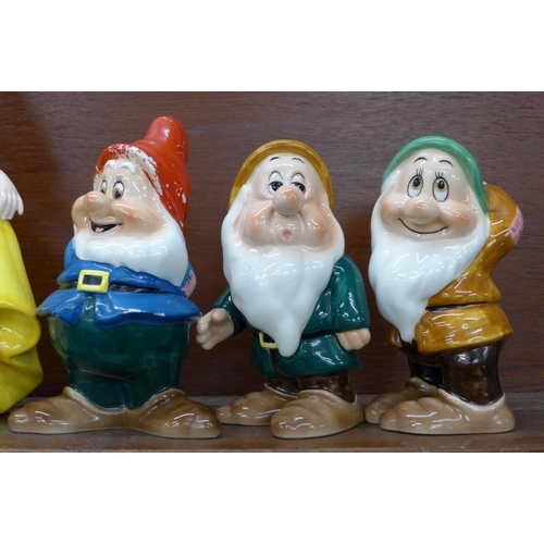 608 - A set of Disney Japan Snow White and the Seven Dwarfs figures, (Snow White, Sneezy, Happy and Doc wi... 