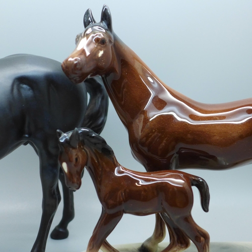 610 - A Beswick horse, Black Beauty and one other horse and foal group