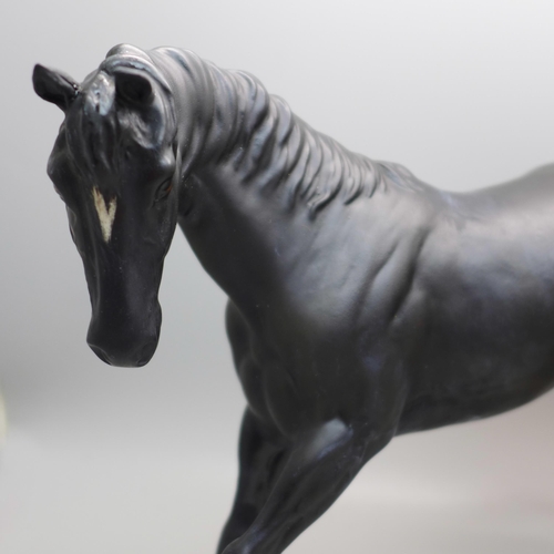 610 - A Beswick horse, Black Beauty and one other horse and foal group