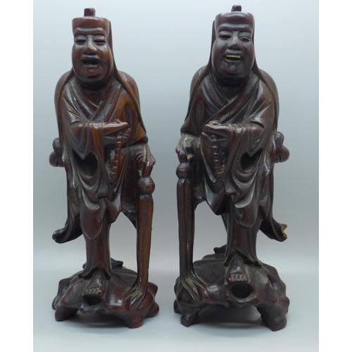 612 - A pair of Chinese hand carved figures of elders, both with small losses, one with bone teeth, 20.5cm