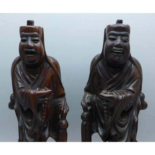 612 - A pair of Chinese hand carved figures of elders, both with small losses, one with bone teeth, 20.5cm