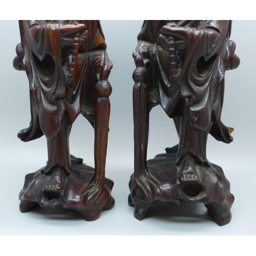 612 - A pair of Chinese hand carved figures of elders, both with small losses, one with bone teeth, 20.5cm