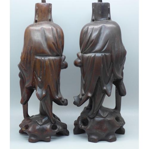 612 - A pair of Chinese hand carved figures of elders, both with small losses, one with bone teeth, 20.5cm