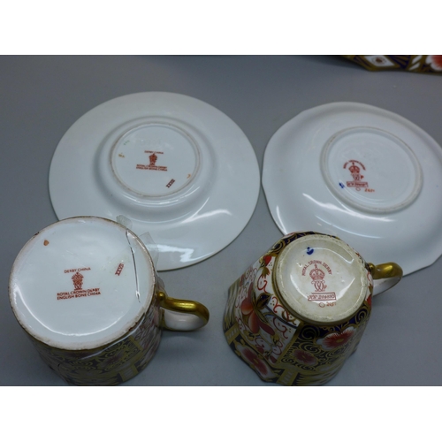 631 - A pair of Royal Crown Derby 2451 pattern plates, cup and saucer and an Imari coffee can and saucer, ... 