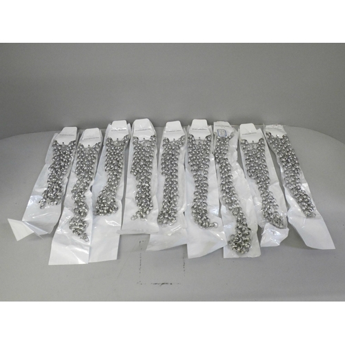 693 - Nine 67cm long stainless steel chains and 21cm bracelets