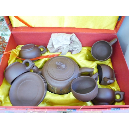 702 - A Chinese terracotta tea service, boxed, a Japanese Imari bowl, a Satsuma dish and rice bowls and co... 