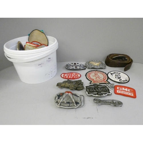 704 - Belt buckles, car badges, cloth patches, etc.