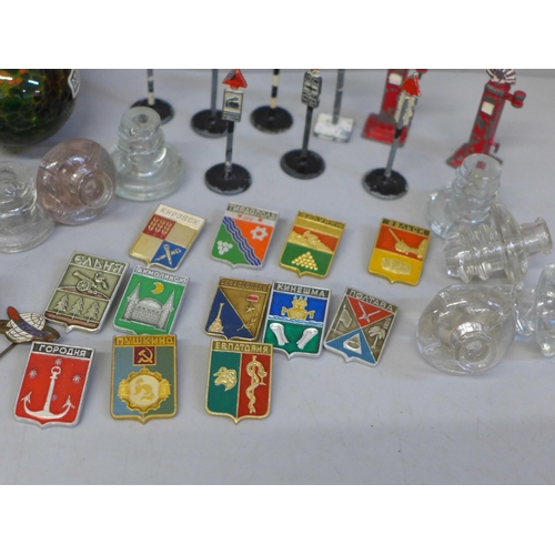 707A - A collection of Soviet badges, glass drawer or cabinet knobs, M'dina and Langham glass paperweights ... 