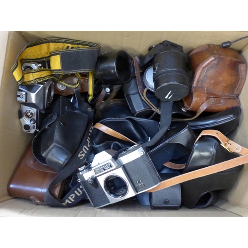 733 - Two boxes of camera accessories, cases, bodies, etc.