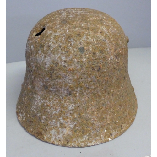 770 - A WWI battle damaged German helmet