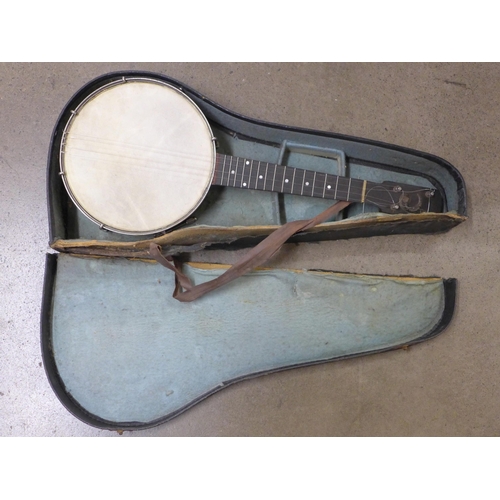 825 - A banjo, cased