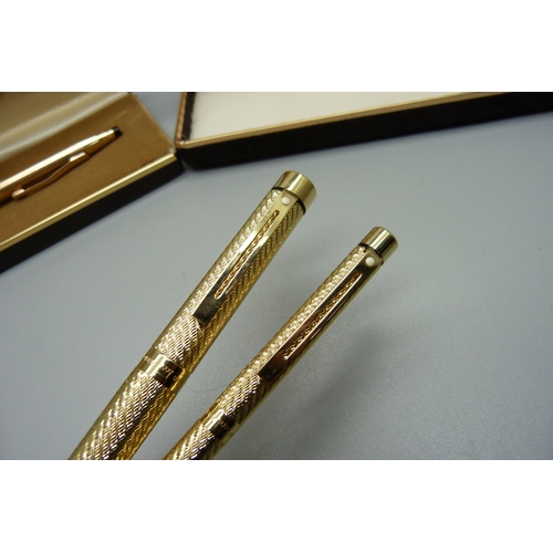 904 - A Sheaffer gold plated pen set, ink pen with 14ct gold nib and a Cross ballpoint pen, both cased