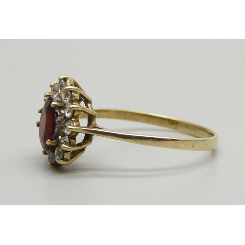 931 - A 9ct gold, garnet and white stone cluster ring, 1.9g, R/S