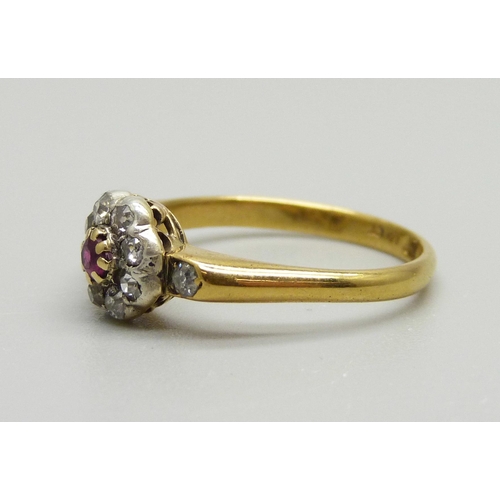 934 - An 18ct gold, ruby and diamond cluster ring with diamond shoulders, 3g, O