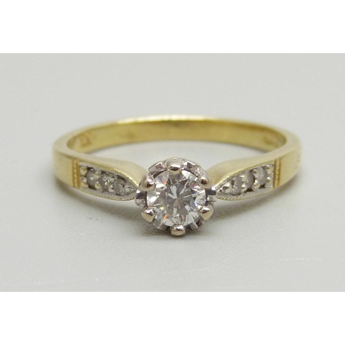 939 - An 18ct gold and diamond solitaire ring with diamond shoulders, 0.3ct diamond weight, 3.6g, O