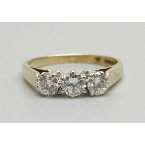 940 - A 9ct gold, three stone brilliant cut diamond ring, Sheffield 1986, 0.8ct diamond weight, 2.3g, N