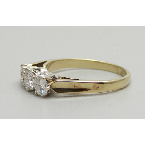 940 - A 9ct gold, three stone brilliant cut diamond ring, Sheffield 1986, 0.8ct diamond weight, 2.3g, N