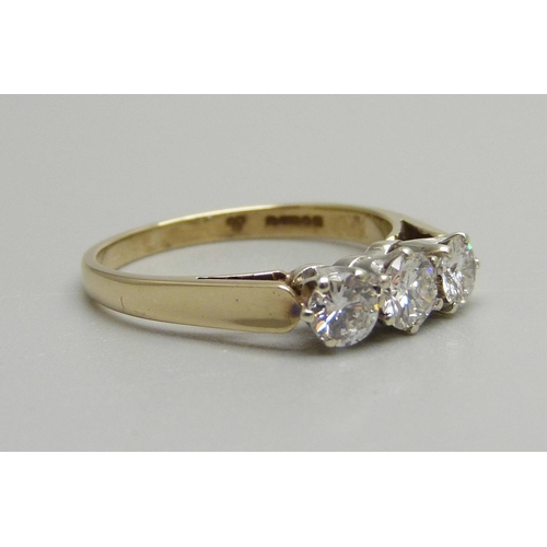 940 - A 9ct gold, three stone brilliant cut diamond ring, Sheffield 1986, 0.8ct diamond weight, 2.3g, N