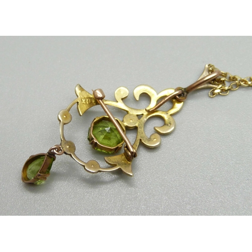 964 - An Edwardian 9ct gold, peridot and half pearl pendant with chain, 5.4g, chain 50cm