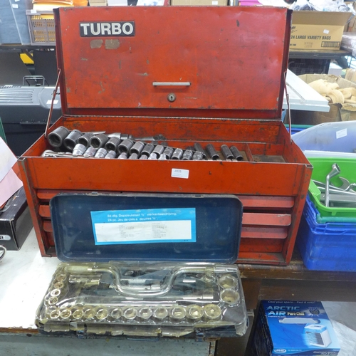 2035 - A red metal tool chest with approximately 70 assorted tools mostly sockets with socket set in tin ca... 