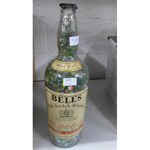 2070 - Bells Whisky bottle full of marbles