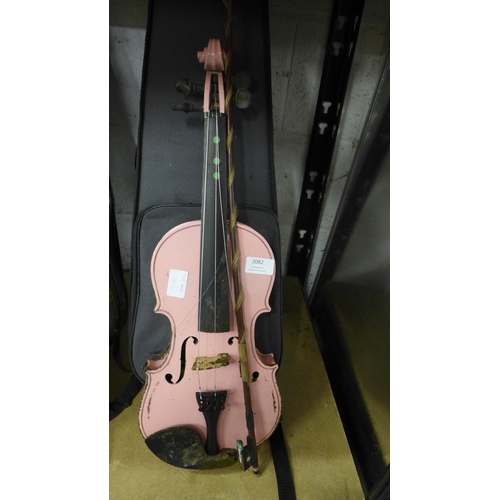 2082 - A pink violin in case - water damaged